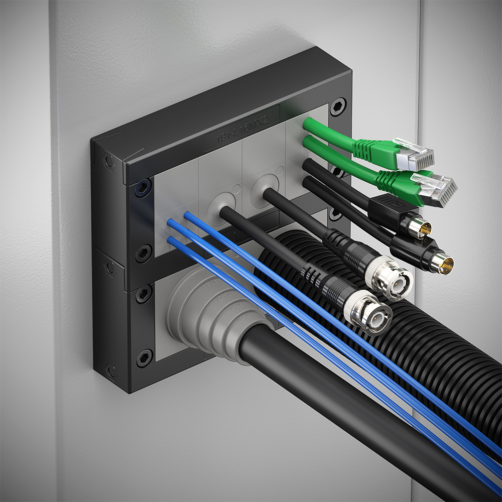 Mehrfach-Kabeldurchführung in einem Schaltschrank mit zahlreichen verlegten Leitungen in verschiedenen Farben, befestigt in einem schwarzen Kunststoffrahmen.